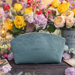 Sage turquoise floral-embossed leather makeup pouch personalized with the name Kimberly