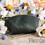 Forest green leather makeup bag with a floral monogram, muscari and poppies around