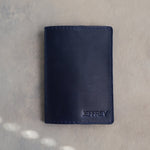 Blueberry leather passport cover with the name JEFFREY in straight capitals pressed into the bottom corner