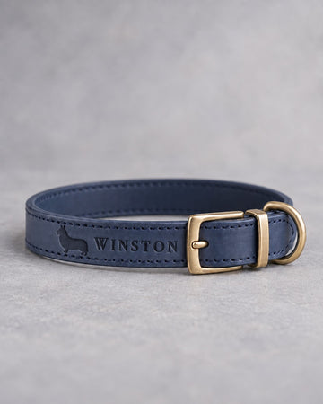 Blueberry blue leather dog collar with a corgi silhouette and the name WINSTON debossed, brass pin buckle