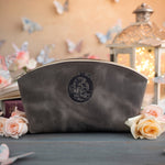 Country gray leather makeup bag with a floral monogram deboss, roses and a lit lantern in the background