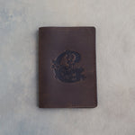 Dark Espresso leather passport cover with a large floral initial C pressed into the front