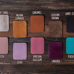 Leather color swatches for the round makeup bag laid out on dark wood