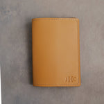 Indian Summer leather passport cover with the monogram JHC with the last initial large pressed into the bottom corner