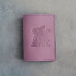 Lilac leather passport cover with a large floral initial A pressed into the front