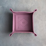 Lilac leather valet tray with snapped corners and the initials NJ pressed into the diamond frame, seen from above