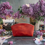 Makeup bag in poppy red leather with a small embossed monogram