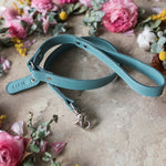 Personalized turquoise leather dog leash with a name tab