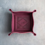 Sangria leather valet tray with snapped corners and the initials CHC pressed into the diamond frame, seen from above
