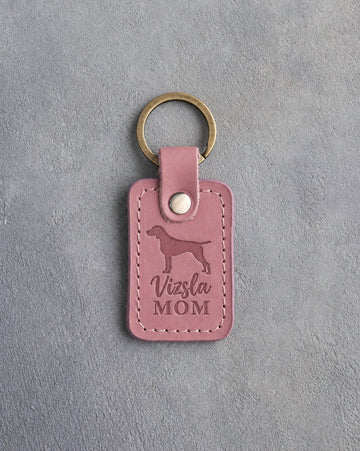 Parisian Blossom pink leather keychain with a debossed vizsla and the words Vizsla MOM, on gray concrete