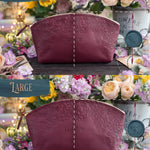 Floral-embossed makeup bag shown in standard and large sizes in burgundy leather