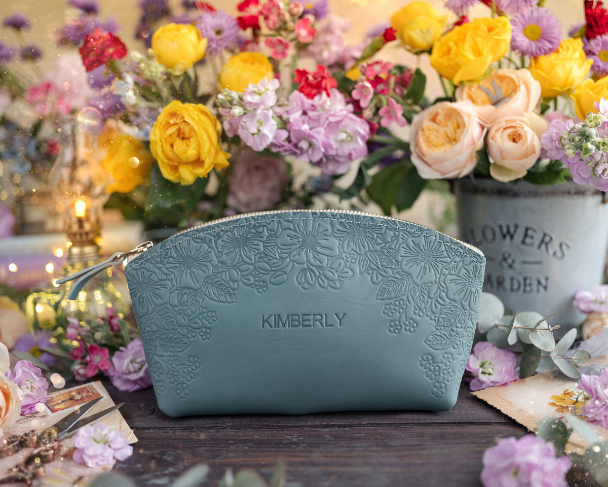 Sage turquoise floral-embossed leather makeup pouch personalized with the name Kimberly