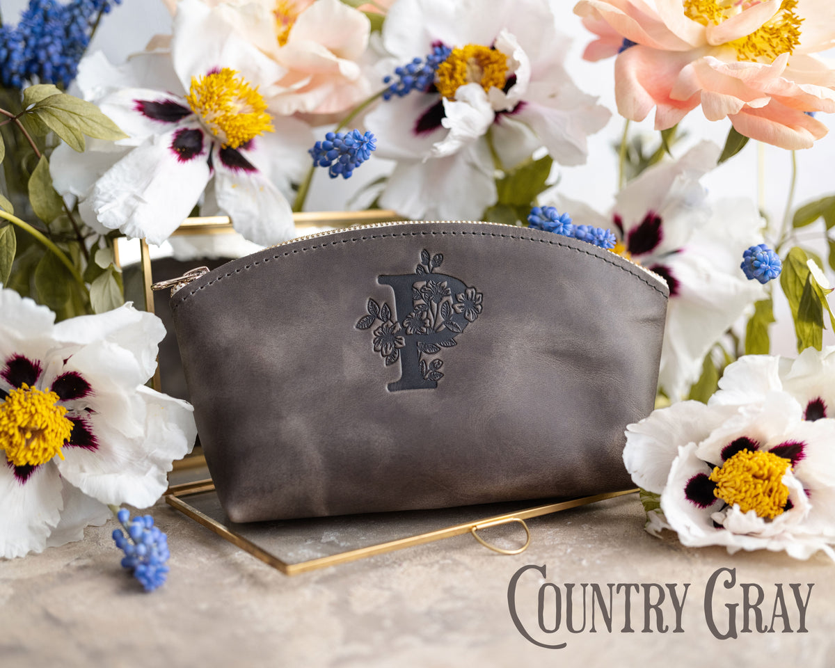 Country gray leather makeup pouch with a floral initial, framed by white poppies