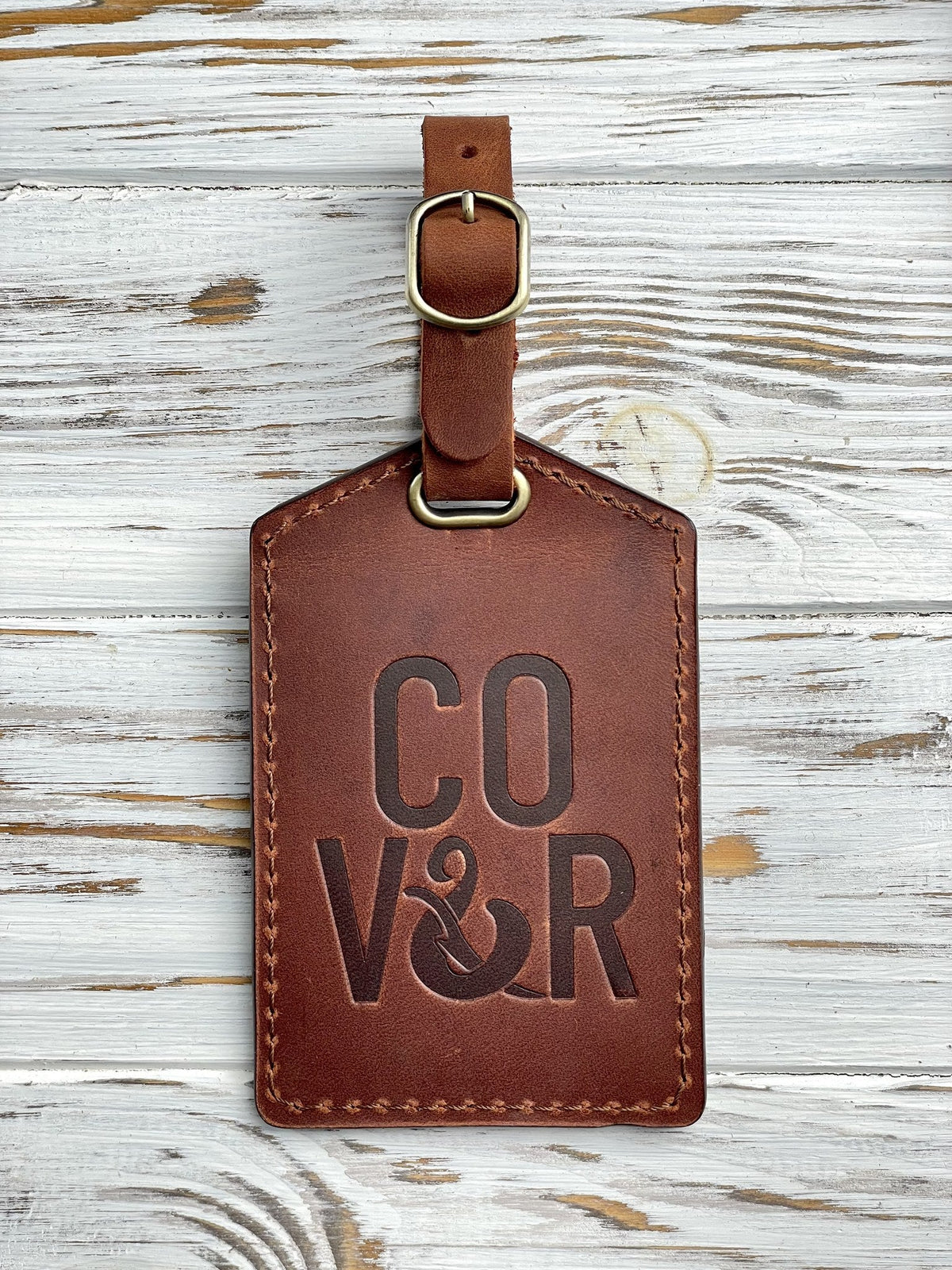 Real logo stamp sample: a company logo blind-debossed into an Arizona leather luggage tag