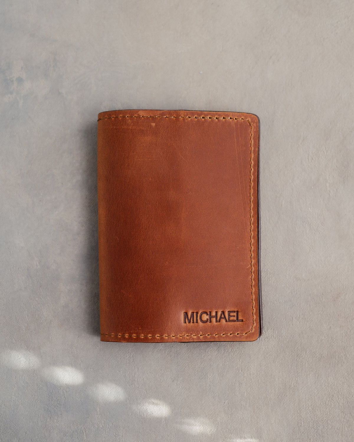 Arizona leather passport cover with the name MICHAEL in straight capitals pressed into the bottom corner