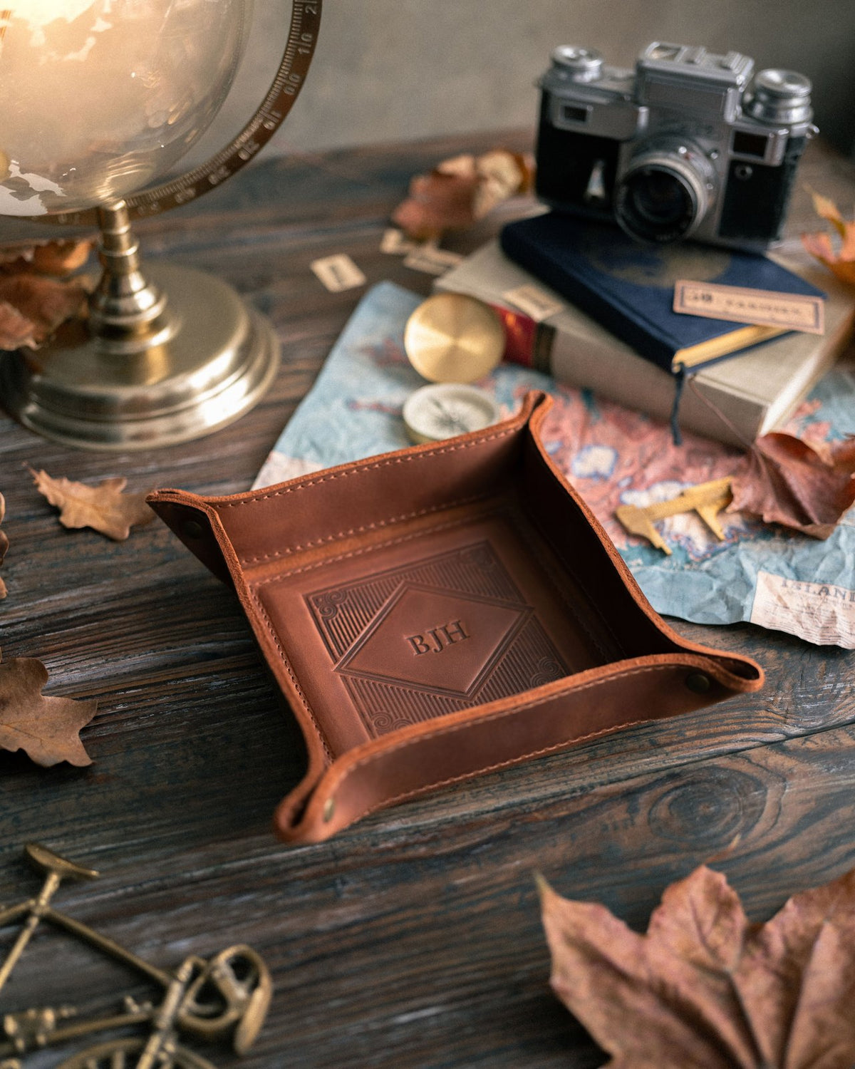 Arizona leather valet tray monogrammed BJH on a wooden desk