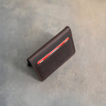 Folded leather card wallet with cards in the outer slots