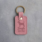 Parisian Blossom pink leather keychain debossed with a Beagle silhouette and the words Beagle MOM, on gray concrete
