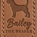 Close-up of Bailey in brush script and THE BEAGLE pressed into caramel full-grain leather beneath a Beagle silhouette