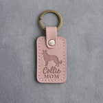 Blush pink leather keychain debossed with a border collie silhouette and Collie MOM lettering, on gray concrete