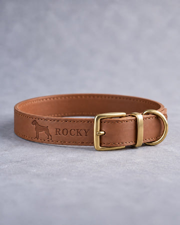 Caramel leather dog collar with a boxer silhouette and the name ROCKY debossed, brass pin buckle