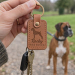 Caramel Rocky the Boxer keychain held in a warm everyday setting