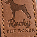 Close-up of Rocky in brush script and THE BOXER pressed into caramel full-grain leather beneath a Boxer silhouette