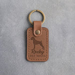 Caramel leather keychain debossed with a Boxer silhouette, the name Rocky and THE BOXER, on gray concrete