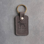 Country gray leather keychain debossed with a Bull Terrier silhouette and Bull Terrier DAD on gray concrete
