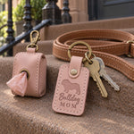 Pink Bulldog Mom keychain on a sofa arm beside a soft wrinkle-wipe towel