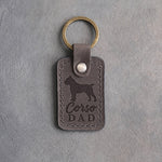 Country gray leather keychain debossed with a Cane Corso silhouette and Corso DAD, on gray concrete