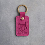 Fuchsia leather keychain debossed with a cat walking with its tail straight up above the words Cat AUNTIE