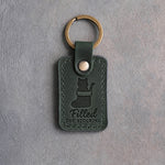 Forest green leather keychain debossed with a cat's head rising out of a Christmas stocking above the words Filled THE STOCKING
