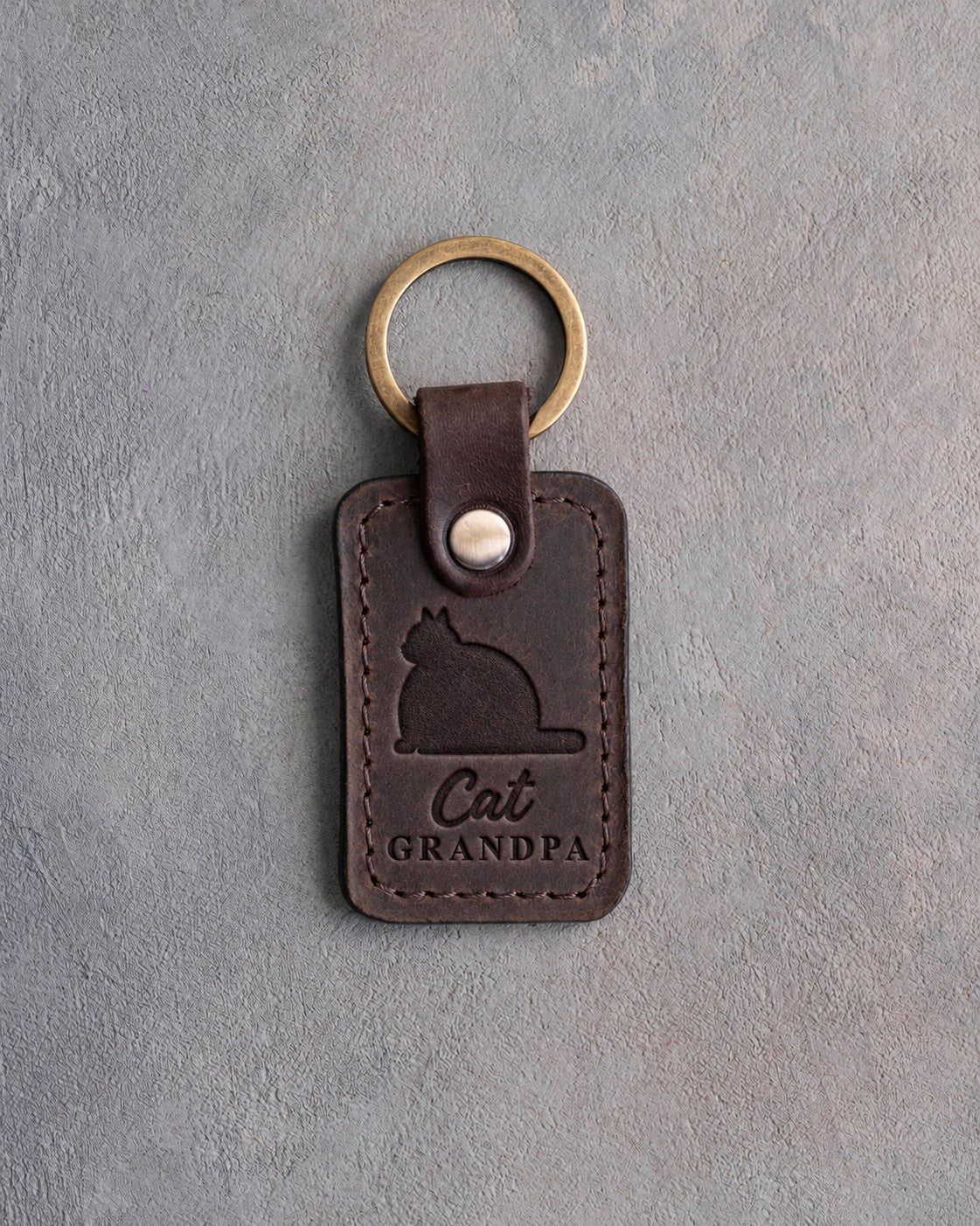 Dark espresso leather keychain debossed with a heavy round tomcat above the words Cat GRANDPA