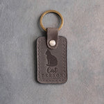 Country gray leather keychain debossed with a sitting cat above the words Cat PERSON