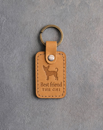 Indian Summer tan leather keychain debossed with a small chihuahua above Best friend and THE CHI, on gray concrete