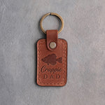 Arizona leather keychain debossed with a crappie above the words Crappie DAD, on gray plaster