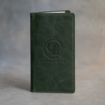 Forest Green leather check presenter debossed with a sample business logo on the front, on a grey plaster backdrop