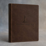 Dark Espresso leather hotel room directory debossed with a sample business logo, on a grey plaster backdrop