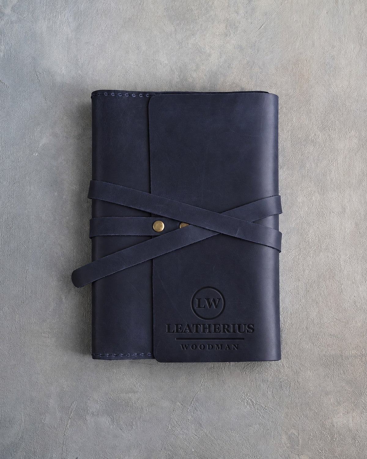 Blueberry leather journal with a logo blind debossed on the cover (sample logo: Leatherius Woodman)