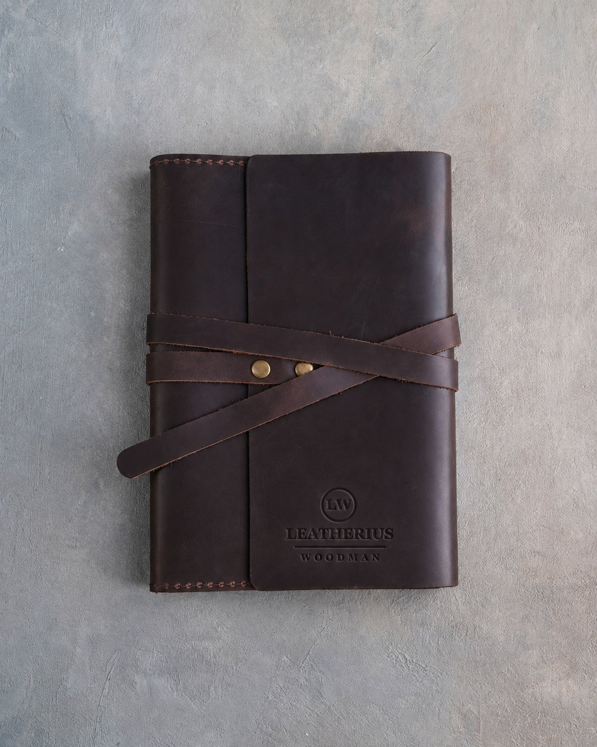 Embossed leather notebook in Dark Espresso with a logo pressed into the cover (sample logo: Leatherius Woodman)