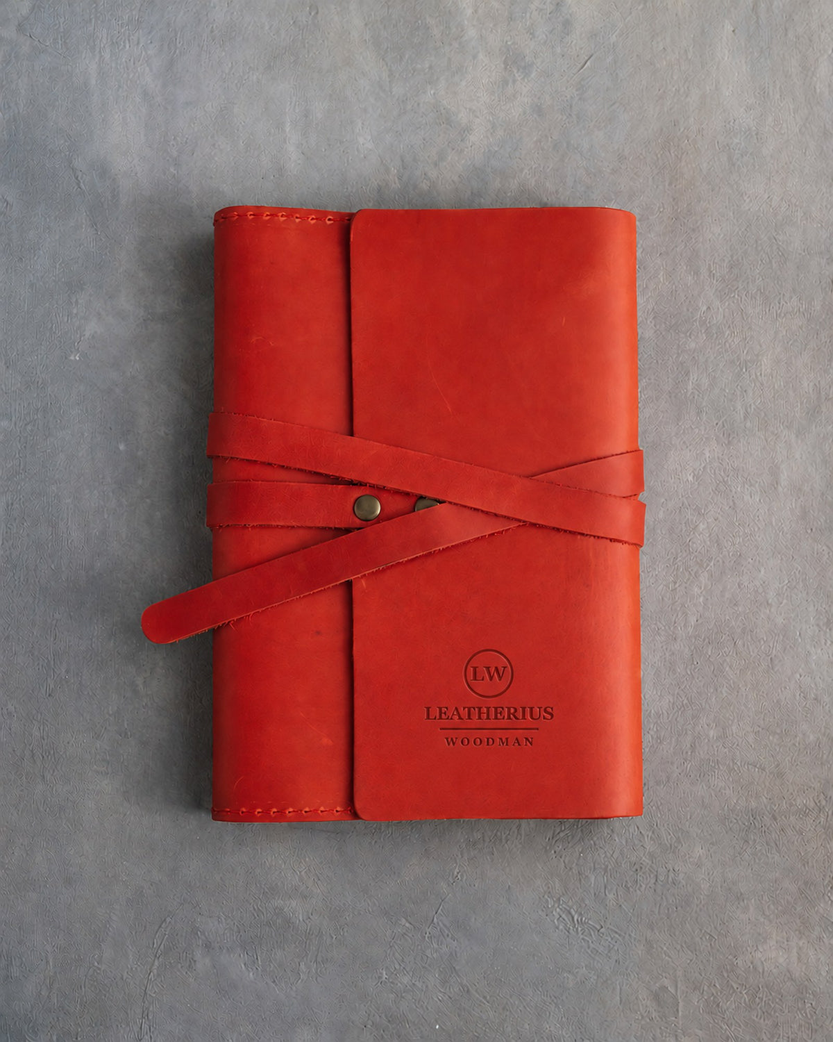 Poppy Red leather journal with a logo blind debossed on the cover (sample logo: Leatherius Woodman)