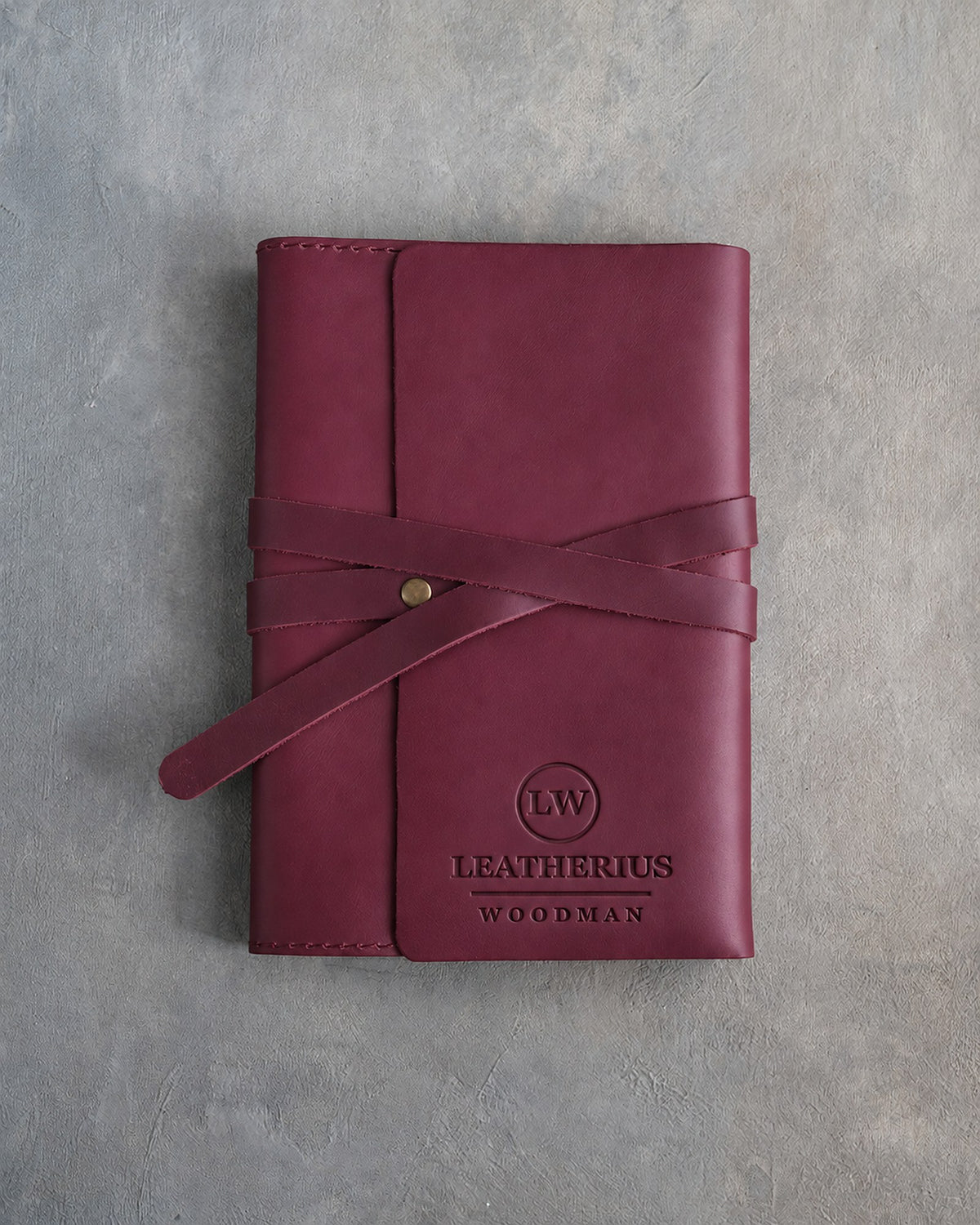 Sangria leather journal with a logo blind debossed on the cover (sample logo: Leatherius Woodman)
