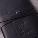 Black leather journal with a client logo blind debossed: From Tree to Beauty for Olive Tree People