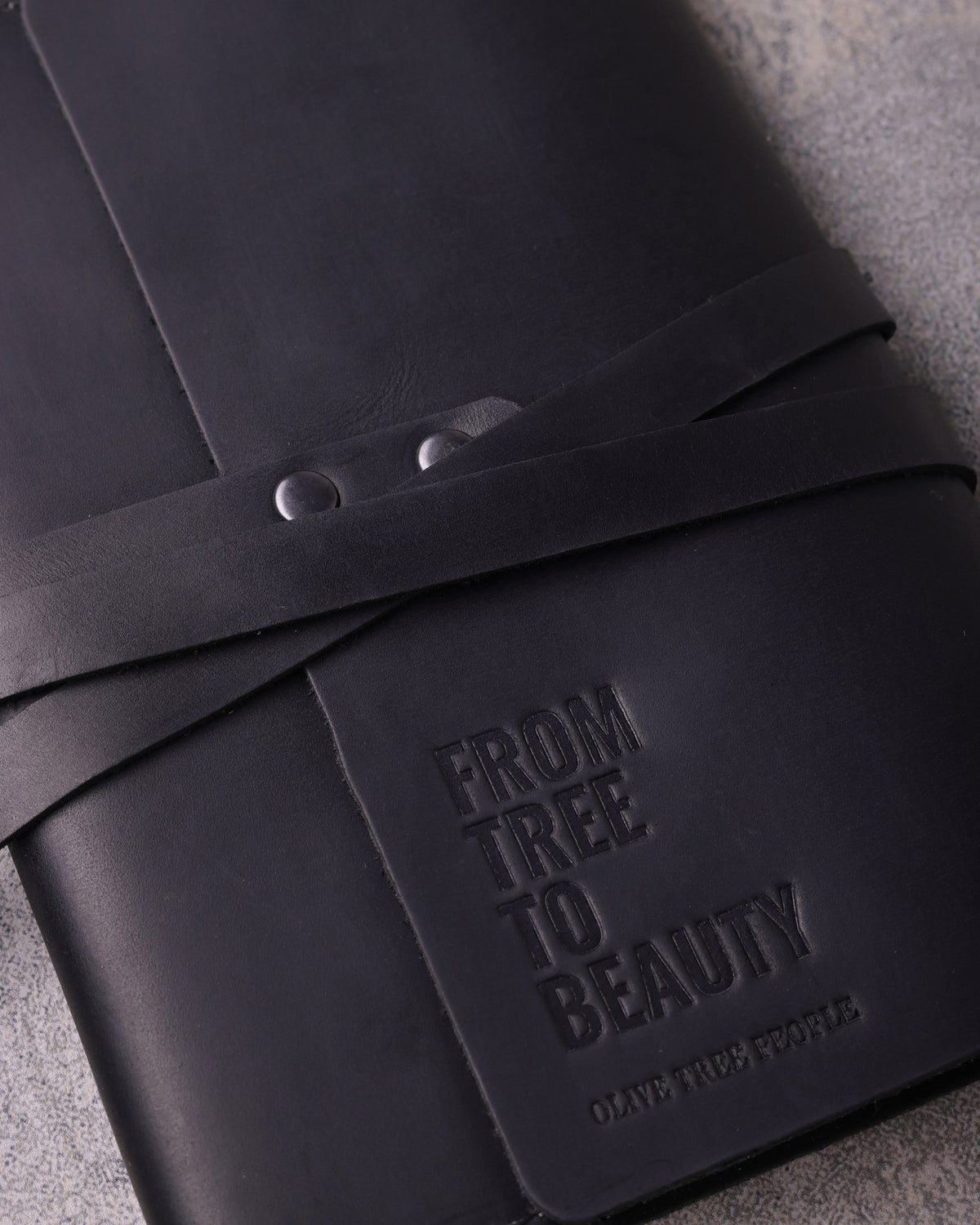 Black leather journal with a client logo blind debossed: From Tree to Beauty for Olive Tree People