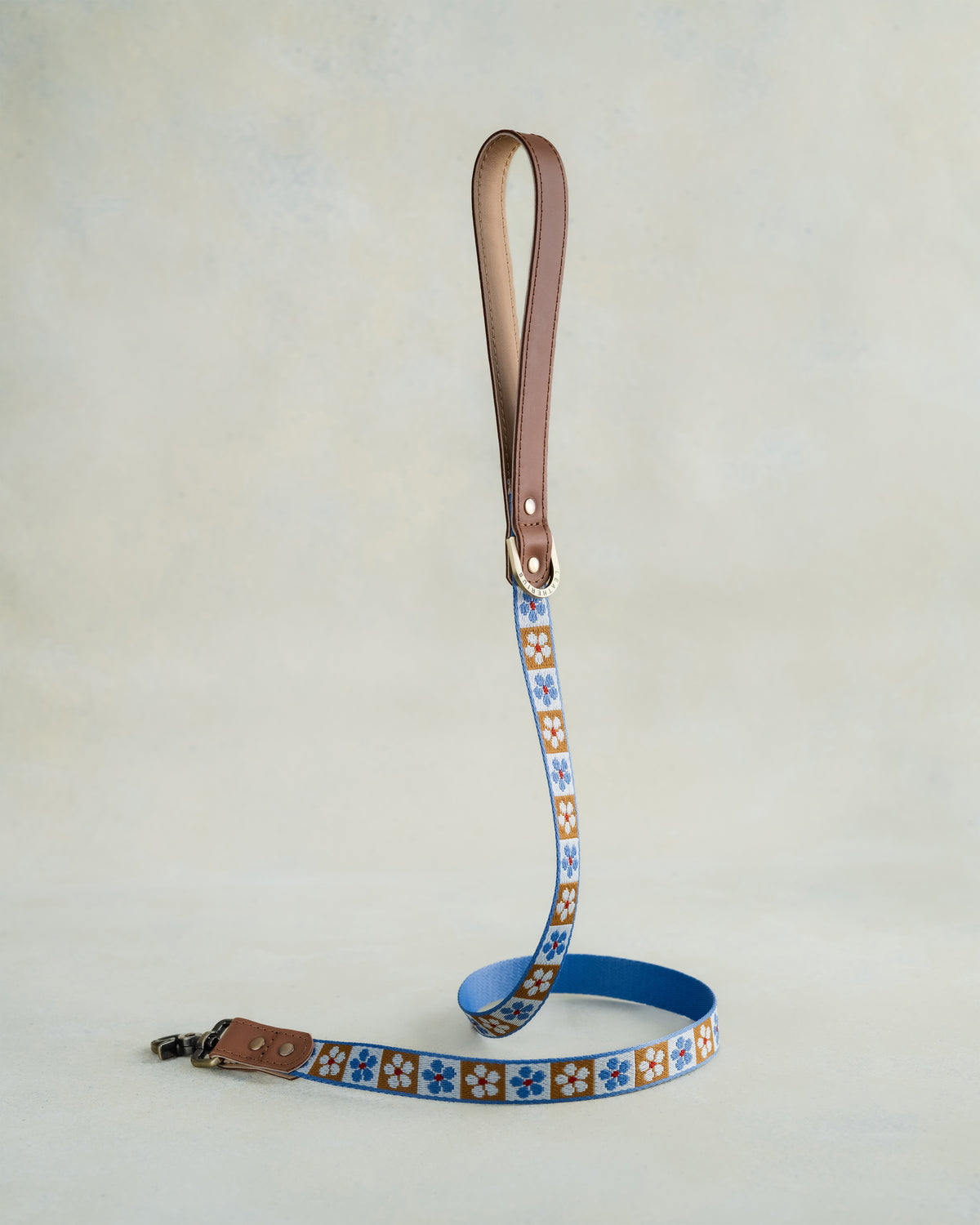 Matching Tan Tiles leash with leather trim and a brass clip