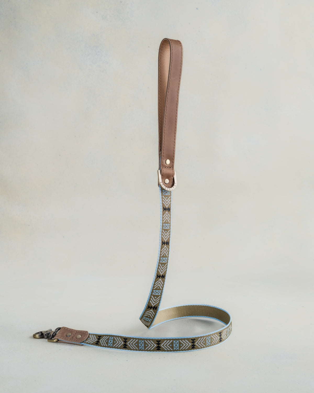 Matching Arrowhead leash with leather trim and a brass clip