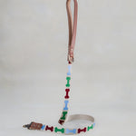 Matching Dog Bones leash with leather trim and a brass clip