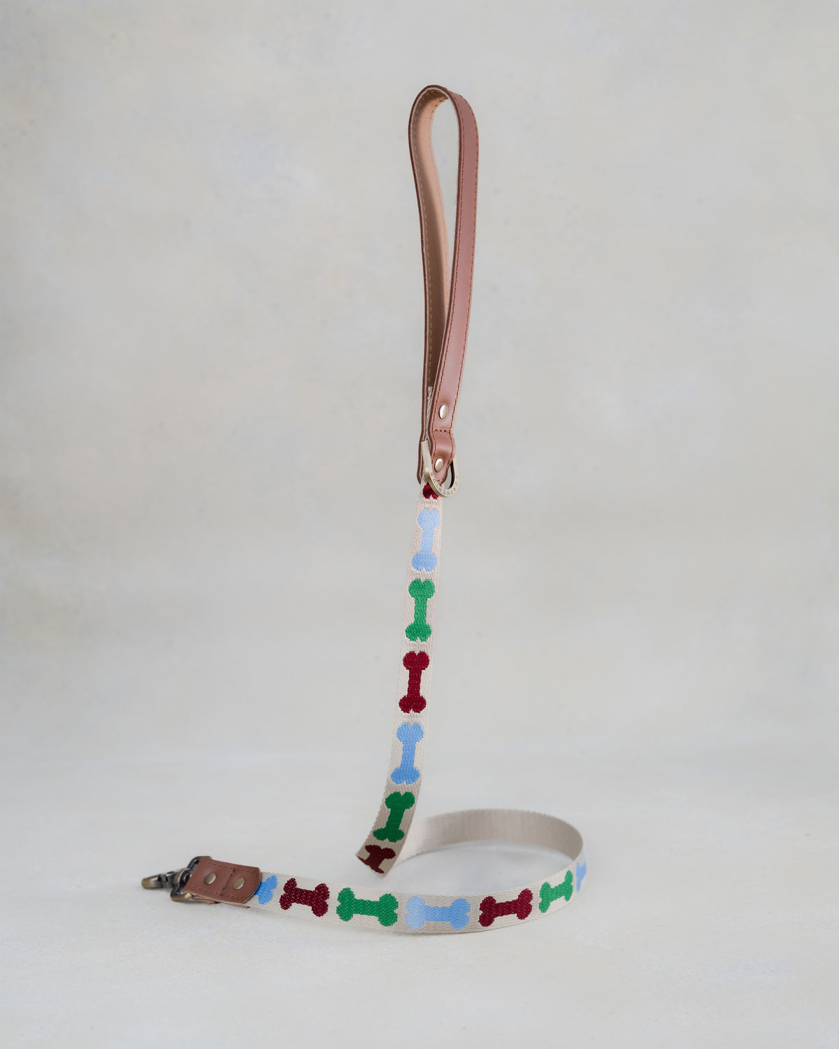 Matching Dog Bones leash with leather trim and a brass clip