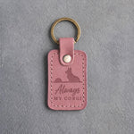 Parisian Blossom pink leather keychain debossed with a corgi seated on a horizon facing a low sun above Always and MY CORGI, on gray concrete